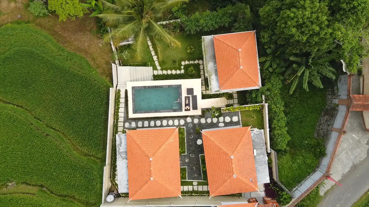 Sun-washed courtyard of a Solmara villa with a curved pool